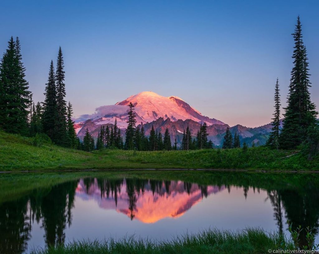 Stationary reflection of Mt Rainier in a pond.